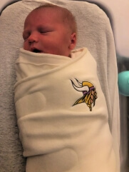 Baby born at St. Luke's Birthing Center September 27, during Vikings game, in a Minnesota Vikings Swaddle Sack